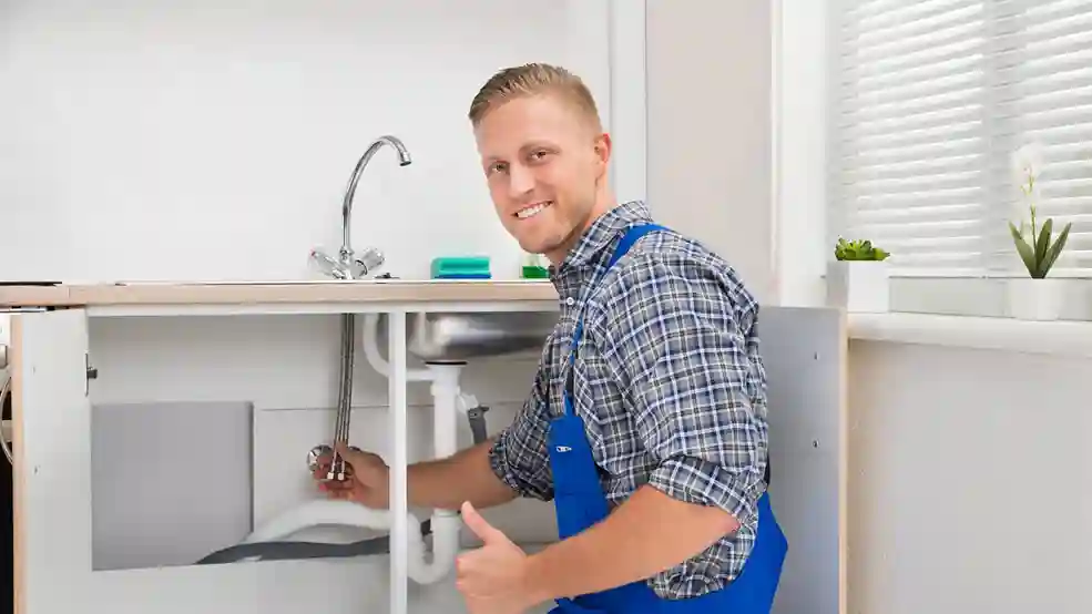 Plumber checking sink plumbing connections